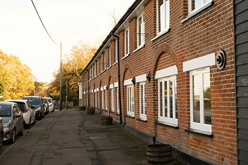 Row of houses next to parked cars